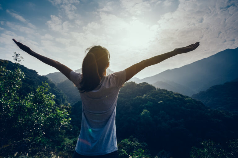 happy woman enjoying the view on morning mountain valley